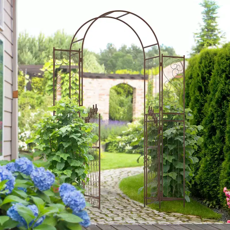 Outsunny 7' Metal Garden Arbor, Garden Arch with Gate, Fleur De Lis Motif, Latching Doors, Planter Shelves, Brown